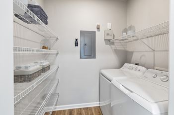 A laundry room with a washer and dryer and a door at Sweetgrass Landing, Mount Pleasant, South Carolina, 29466